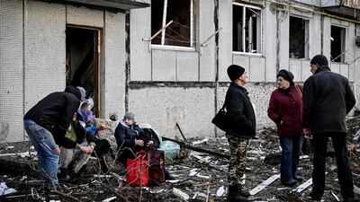 People survey the damage after bombing in Chuguiv. AFP