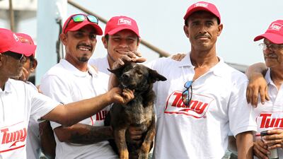 Members of the crew of the Mexican tuna vessel "Maria Delia" pose for a picture with "Bella", Australian sailor Tim Shaddock's dog, after arriving at the port of Manzanillo, Colima State, on July 18, 2023. An Australian sailor and his dog were rescued after more than two months adrift in the Pacific Ocean, surviving the ordeal by drinking rainwater and snacking on raw fish. Shaddock and his dog Bella set off in a catamaran from Mexico's seaside city of La Paz in April, and planned to sail about 6,000 kilometres (3,700 miles) before dropping anchor in tropical French Polynesia. (Photo by ULISES RUIZ / AFP)
