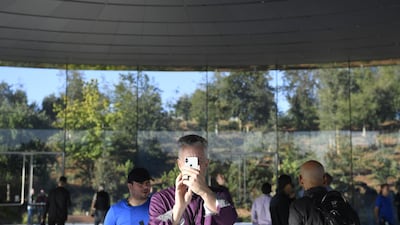 An attendee views an Apple iPhone before the event. Bloomberg