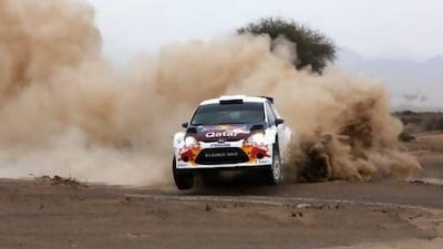 Nasser Al Attiyah tears through the dust on a wet first day of the Dubai International Rally yesterday.