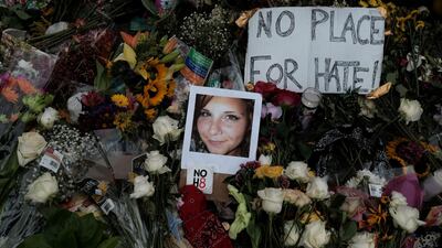 A photograph of Charlottesville victim Heather Heyer is seen amongst flowers left at the scene of the car attack on a group of counter-protesters that took her life during the "Unite the Right" rally in Charlottesville, Virginia, on August 14, 2017. Reuters