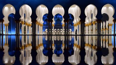 Visitors walking in the courtyard of the Sheikh Zayed Grand Mosque in the UAE capital Abu Dhabi. Giuseppe Cacace / AFP Photo