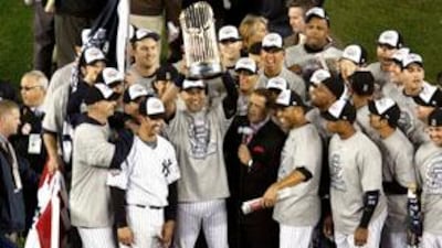 The New York Yankees celebrate with the World Series trophy after defeating the Philadelphia Phillies.