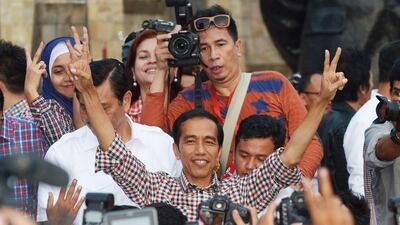 Indonesian presidential candidate Joko Widodo, centre, flashing the victory sign after delivering a speech at Tugu Proklamasi square in Jakarta on July 9, 2014. Both he and his rival Prabowo Subianto have claimed victory to the July 9 presidential polls. Adek Berry/AFP Photo