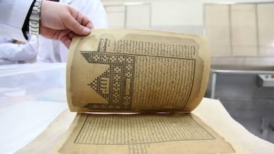 Mohammad Nidal Kalla, head of the restoration section flips the first page of a newly restored 300 year-old Egyptian manuscript.