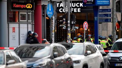 Policemen stand at the intersection of Friedrichstrasse and Kochstrasse in Berlin's Mitte district, where reportedly shots were fired in a cafe. AFP / John MACDOUGALL