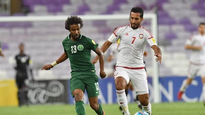 UAE forward Ali Mabkhout, right, beats Saudi Arabia defender Yasir Alshahrani at Hazza bin Zayed Stadium on Tuesday. Giuseppe Cacace / AFP