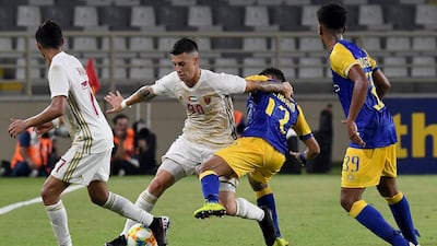 Al Wahda's Nicolas Milesi, left, fights for the ball with Al Nassr's Abdurahman al-Obaid. AFP