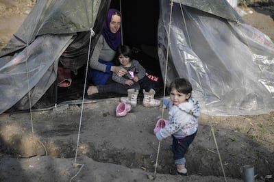 A Syrian woman sits in her tent with her children in the Vial refugee camp, on the Greek island of Chios. Louisa Gouliamaki / AFP