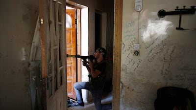 A Free Syrian Army fighter takes up position to fire a rocket-propelled grenade in the Seif El Dawla neighbourhood of Aleppo. Youssef Boudlal / Reuters
