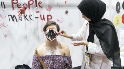 Nouf Al Shaya, a young Emirati makeup artist, works on a truly frightening creation. Reem Mohammed / The National