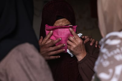 A Palestinian covers her face during a funeral in the city of Khan Yunis in Gaza. AFP