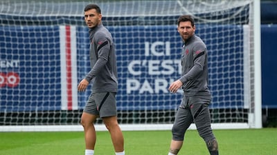 Lionel Messi with Leandro Paredes during training session in Saint Germain-en-Laye, west of Paris., on Monday. AP