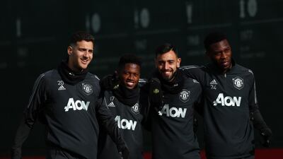 Diogo Dalot, Fred, Bruno Fernandes and Tim Fosu-Mensah of Manchester United arrive for training. Getty Images