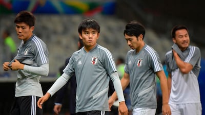 Japan's Takefusa Kubo, dubbed the 'Japanese Messi', warms up with teammates before the match. AFP
