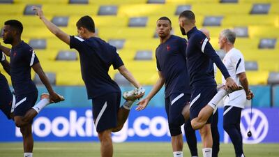 Kylian Mbappe and Karim Benzema stretch during a training session at the Allianz Arena. AFP