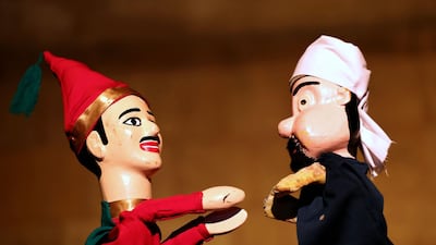 Wooden puppets from Egypt's Aragoz puppets show perform in Beit al-Sehemi, in Cairo's Gamaliya district. AFP