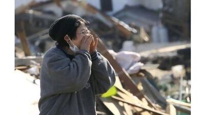 A woman searches for family members in Fukushima prefecture, an area badly affected by the earthquake and tsunami. A reader commends Japan's orderly response to the disaster. Kazuki Wakasugi / The Yumiuri Shimbun / AP