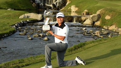 David Lipsky of the US shows off the 2014 Asian Tour Order of Merit trophy after the final round of the Thailand Golf Championship at the Amata Spring Country Club in Chon Buri. Paul Kakatos / AFP