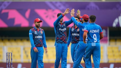Afghanistan's players celebrate the dismissal of Sri Lanka's Dimuth Karunaratne during their warm-up game in Guwahati. AP