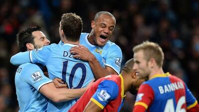 Edin Dzeko, No 10, celebrates with his Manchester City teammates after scoring the only goal in a 1-0 victory over Crystal Palace on Saturday. Andrew Yates / AFP