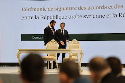 French President Emmanuel Macron and Syrian President Ahmad Al Shara attend a ceremony in Damascus on Tuesday. EPA