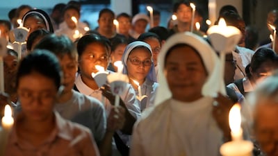 Catholic nuns joins others as they hold candles while offering prayers for the country and also victims of the recent earthquake in Myanmar after a religious procession in observance of lent, in Quezon city, Philippines. AP