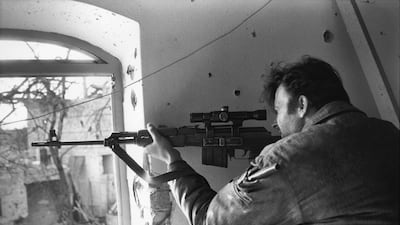 A Serbian sniper fires through a window in Brcko, in north-eastern Bosnia, in March 1993. Getty Images