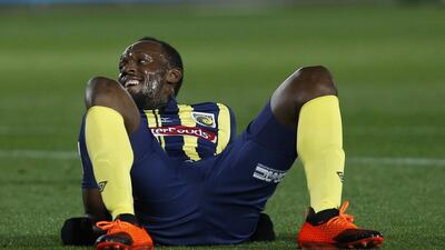 Usain Bolt lies on the pitch after taking a shot at goal during a pre-season friendly for Central Coast Mariners. AP Photo