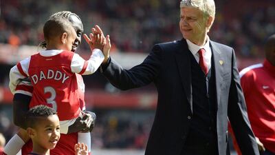Arsenal manager Arsene Wenger greets Bacary Sagna's children as they walk around the pitch after their win over West Bromwich Albion on Sunday. Dylan Martinez / Reuters / May 4, 2014
