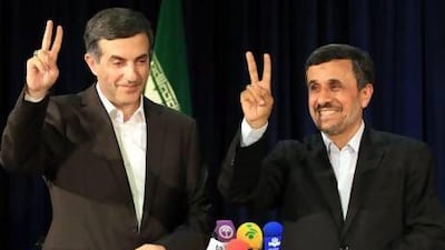 Iran's president Mahmoud Ahmadinejad, right, and presidential candidate Esfandiar Rahim Mashaie flash the victory sign after Mr Mashaie registered his candidacy yesterday in Tehran. Abedin Taherkenareh / EPA