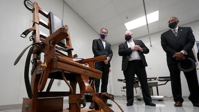 Virginia Governor Ralph Northam looks at an electric chair before signing a bill abolishing the death penalty in Virginia. AP