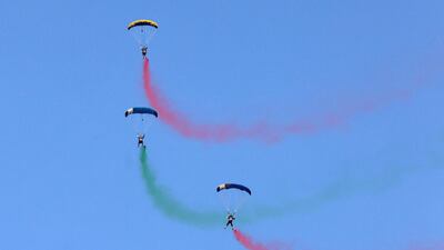 Parachutists leave smoke trails as they perform at Dubai Marina. AFP
