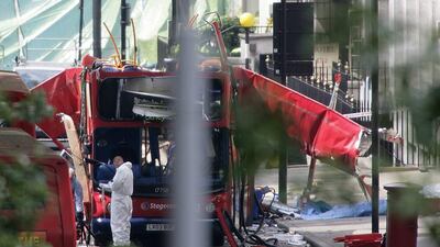 Forensic investigators examine the remains of the bombed out bus in Tavistock square in London. Ten years on from the 7/7 attacks, the extremist threat is very different. (AFP Photo/Odd Andersen)
