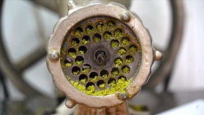 A pistachio grinder in Al Daouk Sweets in Beirut, Lebanon. Pistachio paste is a key ingredient in the shop's famous Daoukiye Ramadan dessert. Mahmoud Rida / The National