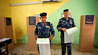 Federal policemen prepare to cast their votes at a polling station in Basra, 550 kilometres southeast of Baghdad, Iraq, on May 10, 2018. Nabil Al Jurani / AP