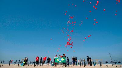 A thousand red balloons are released during a tribute to Covid-19 victims organised by the Rio de Paz NGO at the Copacabana beach in Rio de Janeiro, Brazil. AFP