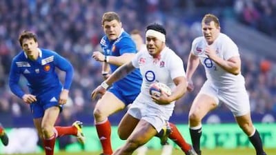 England's centre Manu Tuilagi, centre, breaks through the French defence during a Six Nations international rugby union match on Saturday. Adrian Dennis / AFP