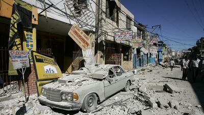Haitians walk past damaged buildings in Puerto Principe after a quake with a magnitude of 7.0 struck in January 2010, killing more than 100,000 people