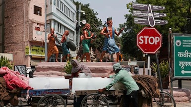 Vendors unload ice blocks from carts to sell on a hot summer's day in Varanasi, India, where the temperature has reached 44°C in recent days. AFP