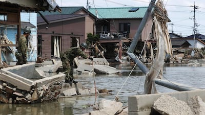 Searchers look for missing people in a residential district devastated by heavy rains in Kurashiki, Japan. EPA