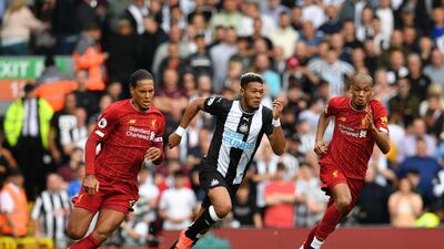 Liverpool's Dutch defender Virgil van Dijk and Liverpool's Brazilian midfielder Fabinho vie with Newcastle United's Brazilian striker Joelinton. AFP