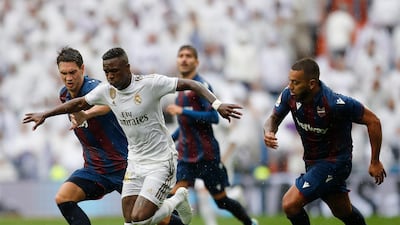 Real Madrid's Vinicius Junior, second left, vies for the ball with Levante defenders. AP Photo