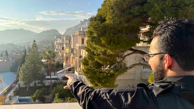 Abu Al Mughwar points out the views of Damascus from the palace roof