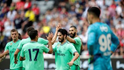Madrid players celebrate Benzema's hat-trick. Getty