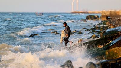 A Palestinian fisherman prepares to cast his net. AFP