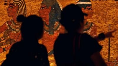 Visitors look at ancient Egyptian drawings. Reuters