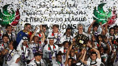 Al AIn players celebrate with the trophy after winning the Etisalat Pro League