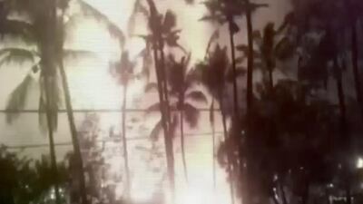 In this image taken from a video, a flash from an explosion is seen from the ground during a fireworks show at a temple in Kollam, in the southern Indian state of Kerala. More than 80 people were killed. KK Productions / AP Video