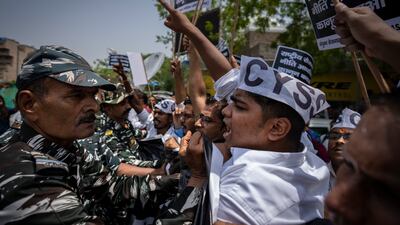Indian paramilitary personnel try to stop students and activists in New Delhi. AP